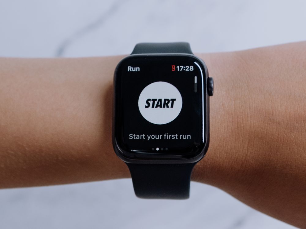 A smartwatch on a wrist showing biometric readings