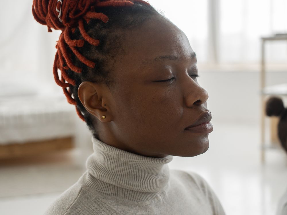 A person meditating calmly in a bright, airy room